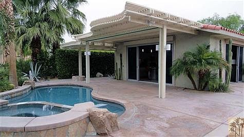 Covered patio with roll-down sun screens, misting system.  Sliding glass doors include roll-down security shutters.