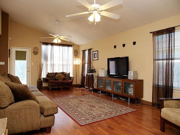 Wood laminate flooring in living, kitchen and foyer