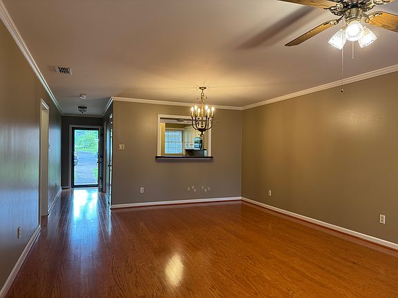 Living / Dining area looking to front door and Kitchen.