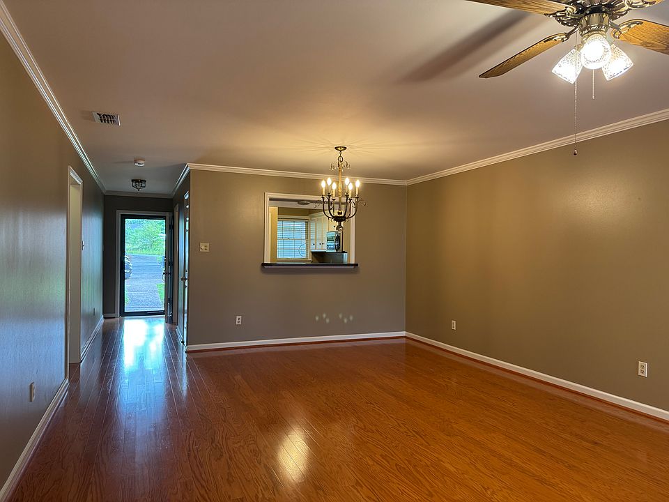 Living / Dining area looking to front door and Kitchen.