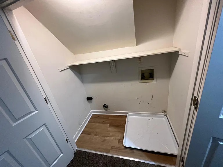 Upstairs washer and dryer at the end of the hallway, closest to bedroom 3 (above the garage)