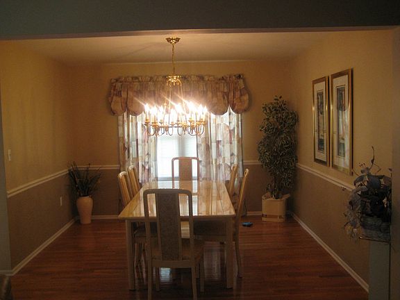 Formal dining room features hardwood floors.
