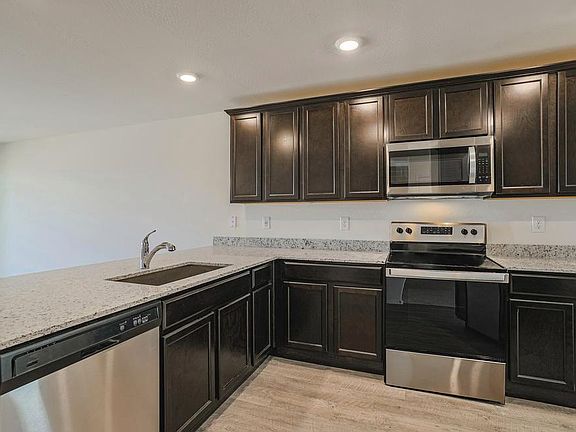 Kitchen with granite countertops and whirlpool appliances