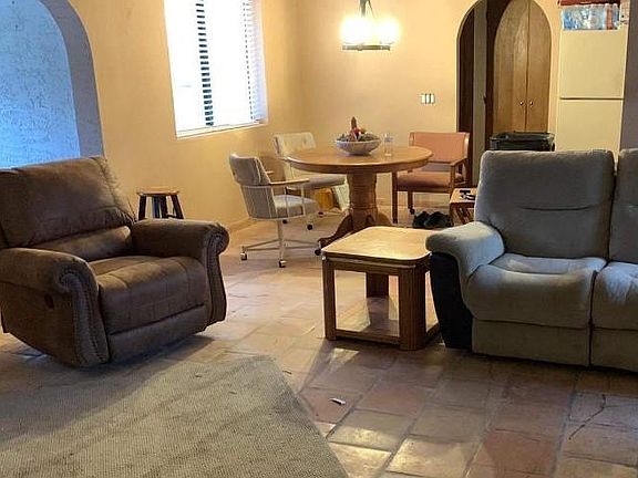 Temporary furniture, rug used by handyman restoring the house.