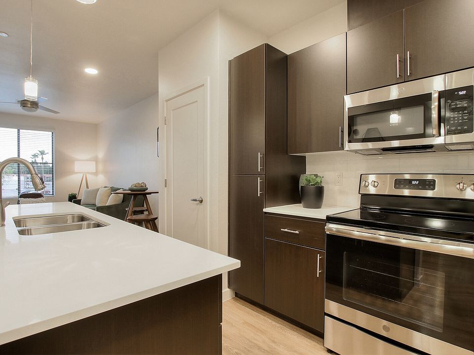 Stainless steel range and microwave and kitchen island with under-mount sink.