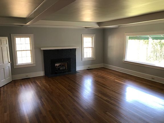 Gorgeous refinished hardwoods in living room. Beamed ceilings add elegance and style.