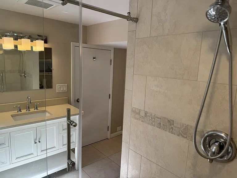 Renovated basement bathroom with Italian porcelain tile and underfloor heating.