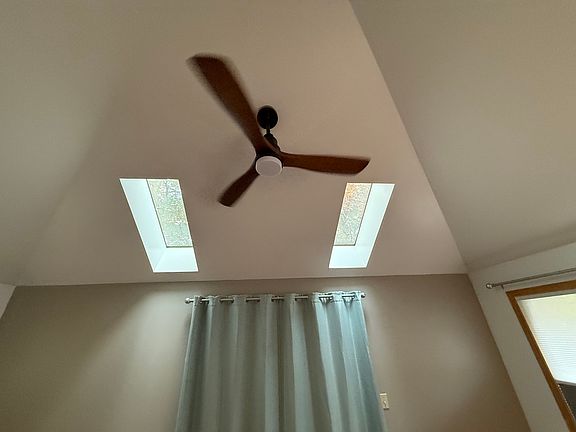 Vaulted ceiling in living room with new ceiling fan