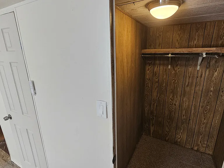 The photo shows the previous flooring before upgrades; the home now features freshly installed LVP that
