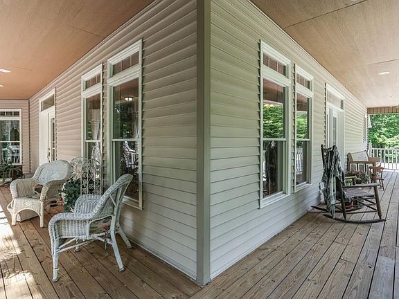 Generous porch allows for multiple seating areas and access points into the home.