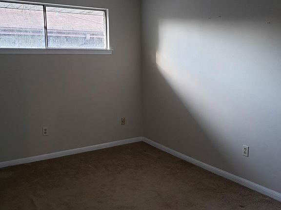 first bedroom with carpet and ceiling fan