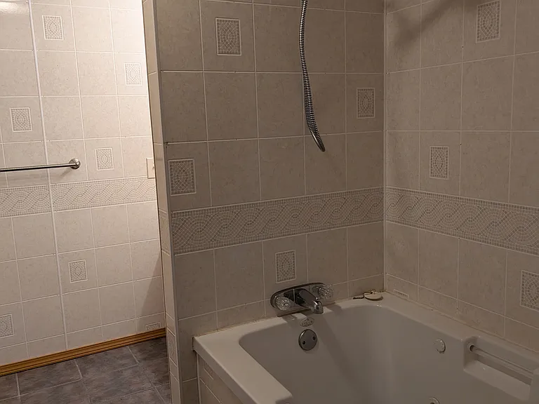 basement bath has tub and walk in shower