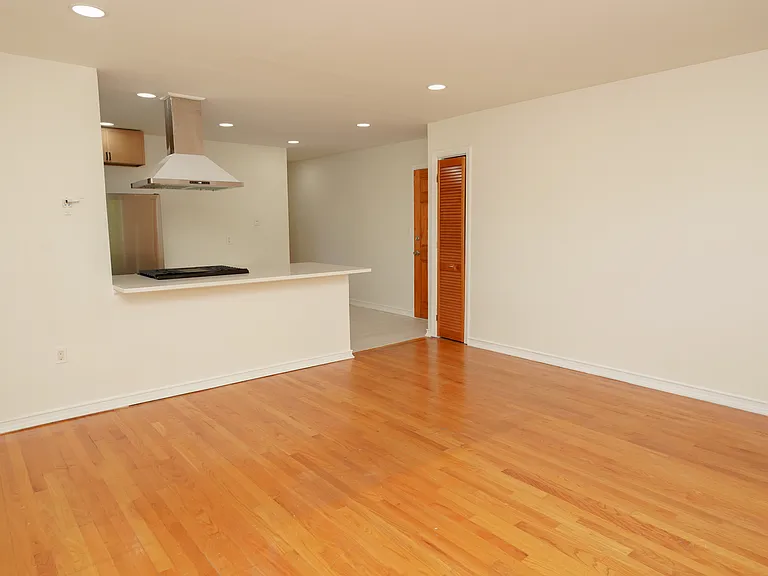 View of open concept space. Coat closet and Back entrance