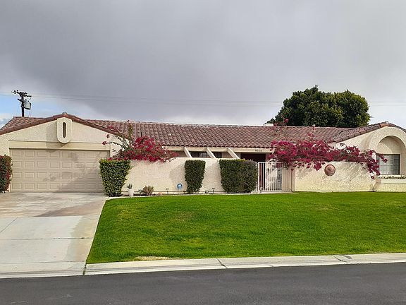 Home Front view showing two car garage. Big Front Yard.