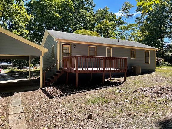 back of home and deck, door that leads to kitchen