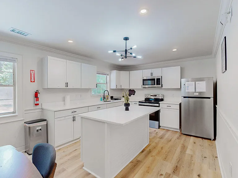 Spacious kitchen with a large island, ample white cabinetry, and stainless-steel appliances for easy everyday cooking.