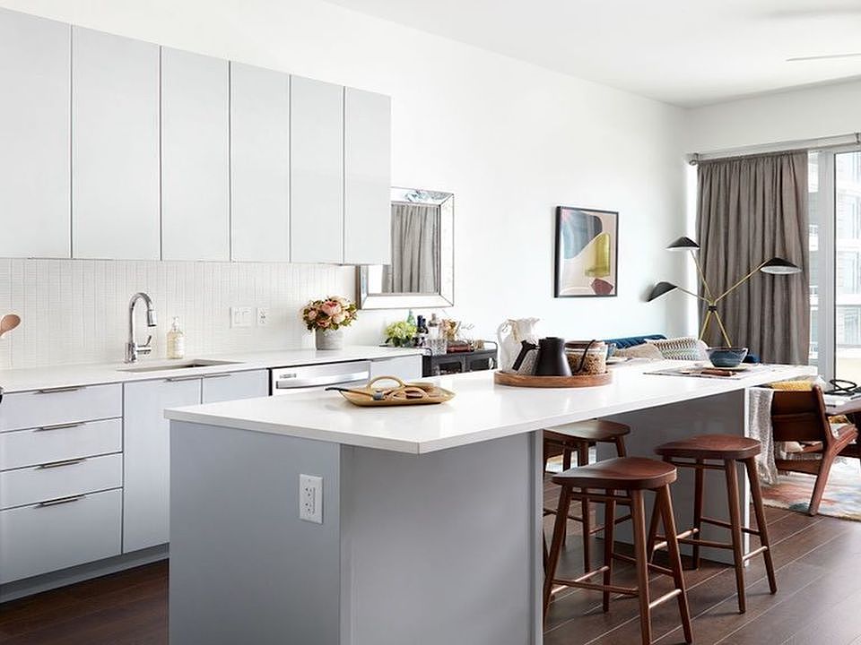 Light-filled apartments with custom cabinetry, stainless steel appliances and islands with bar seating.