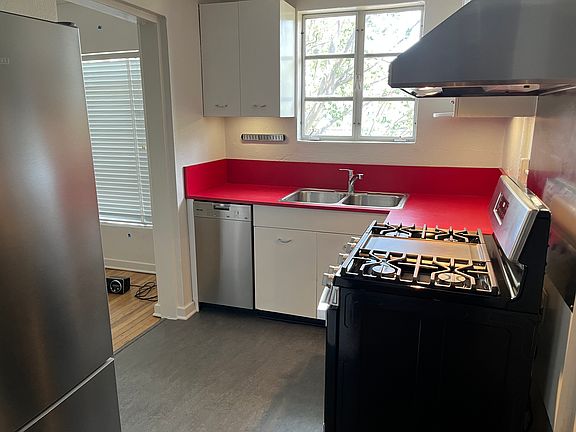 Kitchen featuring higher end appliances and under cabinet lighting