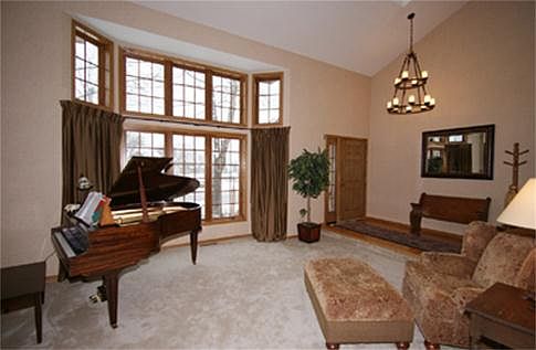 Nearly floor to ceiling windows brighten the formal living space.