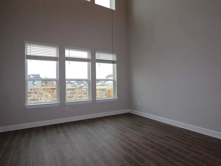 Bright, spacious living room with soaring ceilings and abundant natural light_perfect for relaxing or entertaining with plenty of room to gather.