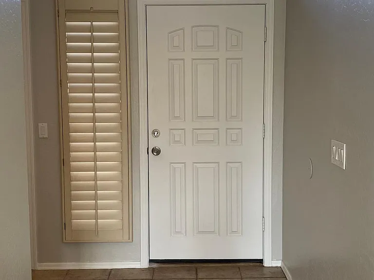 front door and hallway facing from living room to door