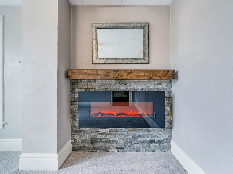 electric fireplace with custom stone surround and mantel