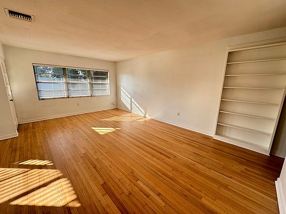 Family Room with beautiful Oak wood floors and built in book shelf