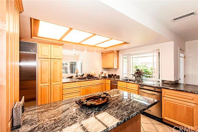This kitchen has top of the line appliances, granite countertops, maple cabinets