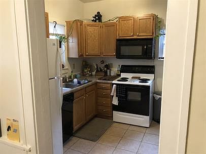Electric stove, microwave, dishwasher in the small but quaint kitchen.