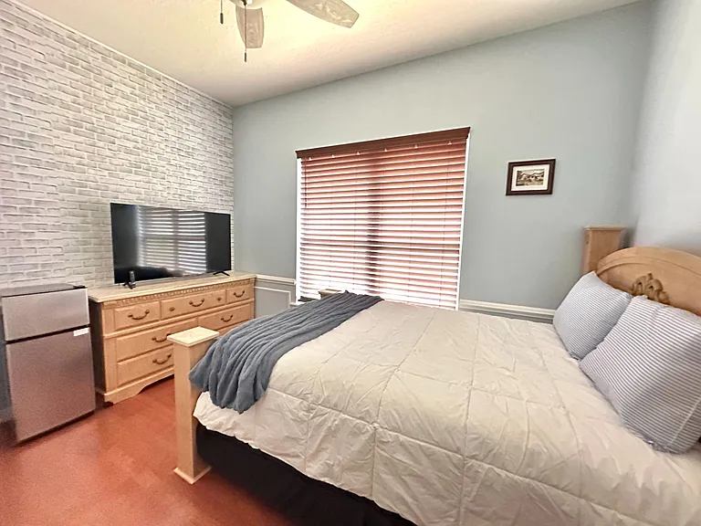 Furnished bedroom with a queen bed.