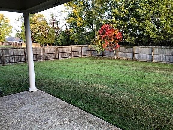 Covered patio and fenced back yard