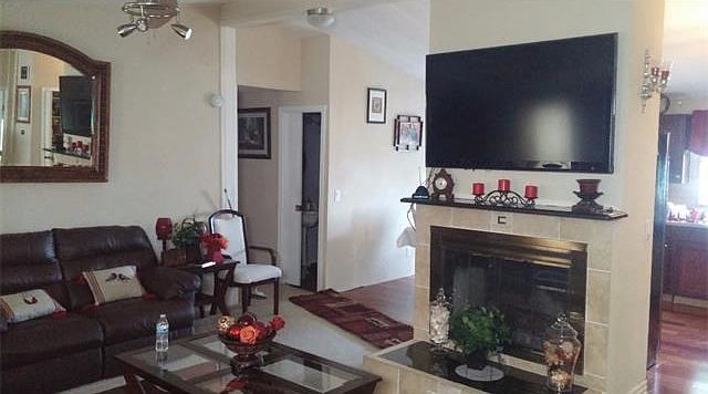 Living Room with fireplace and adjoining Dining Room and Kitchen.