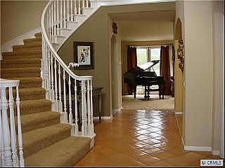 Wide open entry with impressive flowing staircase.