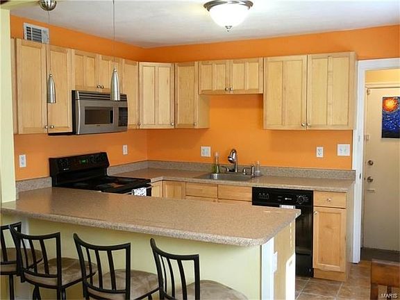 Stylish updated kitchen with electric stove, microwave, and dishwasher. Breakfast bar for easy entertaining.