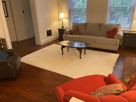 Living room with tall windows facing onto Connecticut Street.
