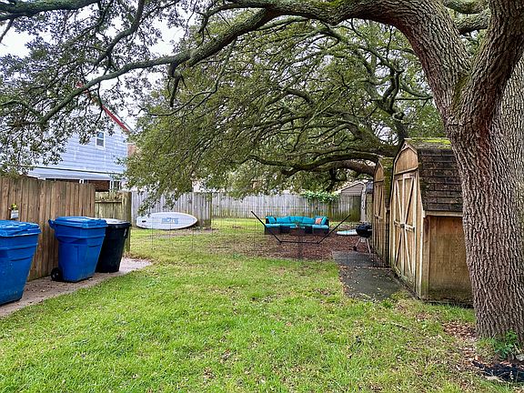 Shared grass backyard. Each side has their own shed.