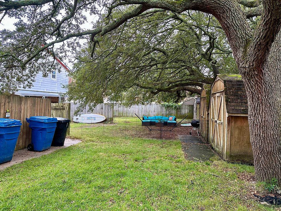 Shared grass backyard. Each side has their own shed.