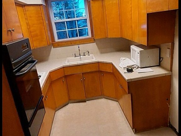 Kitchen with gas wall oven and cooktop