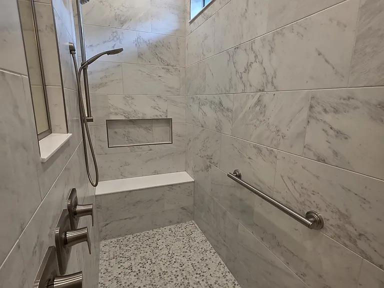 Primary walk-in shower. The body stays dry until you enter the 3-shower-head area. GENIUS