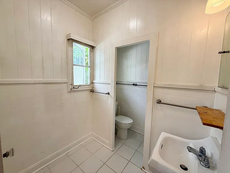 Quaint white bathroom with space to add your personal touch