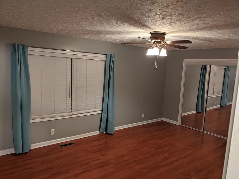 master bedroom with blinds and black out curtains