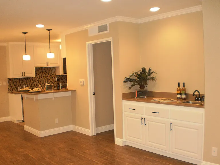 Spacious living room with hardwood floor and built-in wet bar