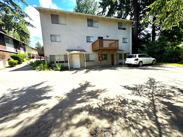 West side of building with driveway to large parking area