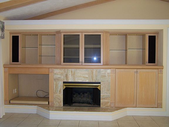 Great room has cathedral & beamed ceiling with fireplace and built-ins.