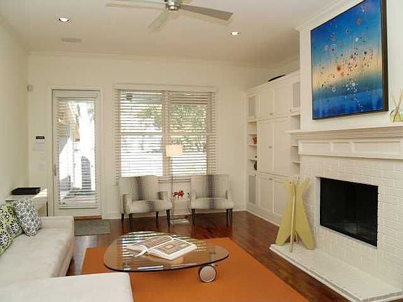 Living open to kitchen, firplace + custom cabinetry for media/books, beautiful