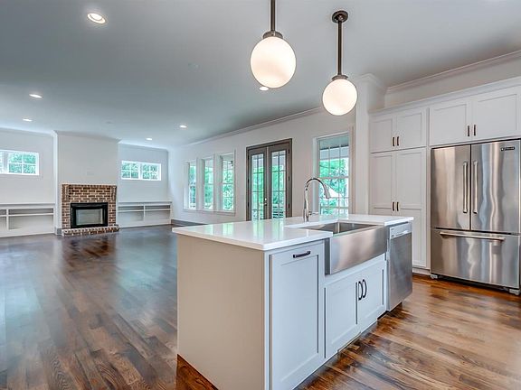 Beautiful quartz countertops, stainless farm sink and counter-depth Jenn-Air refrigerator