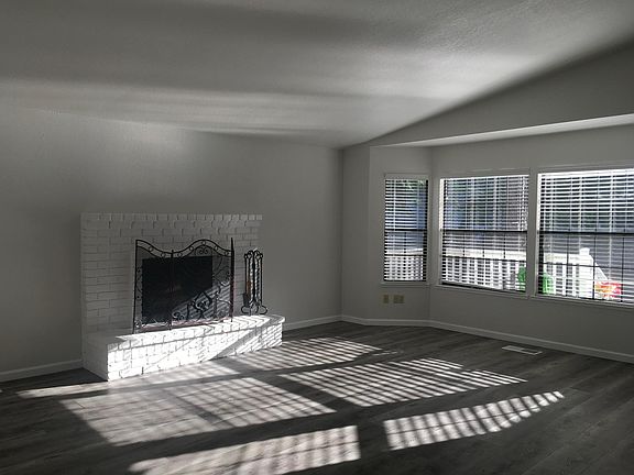Fireplace in living room. New high quality plank flooring.