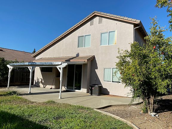Backyard covered porch and pomegranate tree