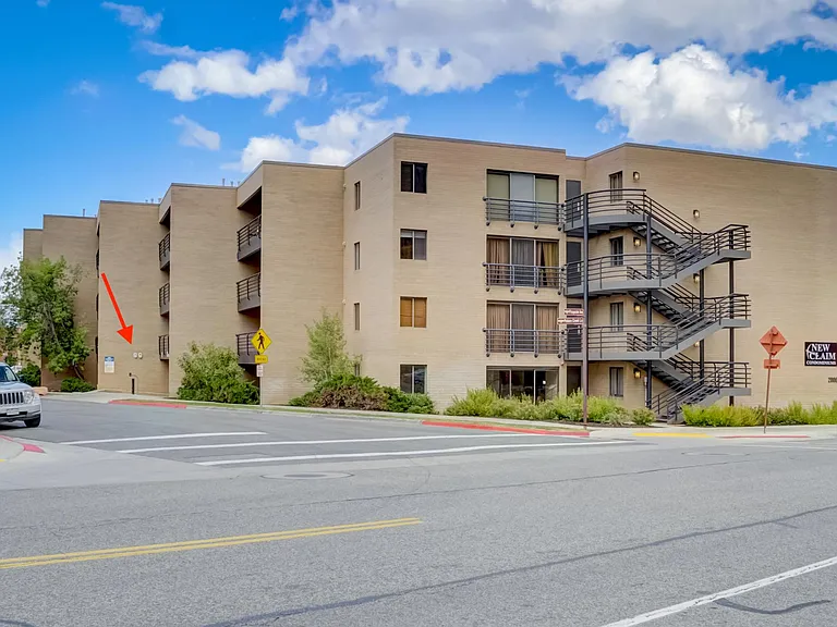 Exterior of New Claim Condos. The red arrow indicates the entrance to the parking garage.