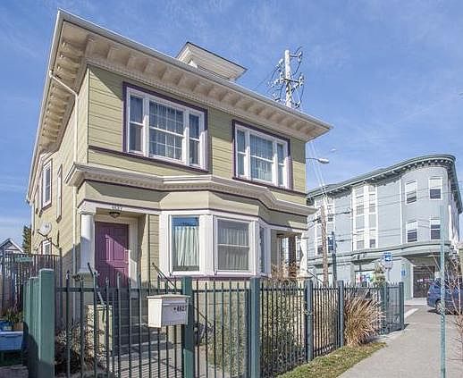 Entry on door on right. Private gate and doorway into unit which fills entire main floor of house. 
Left door goes up stairway to two upstairs units.
